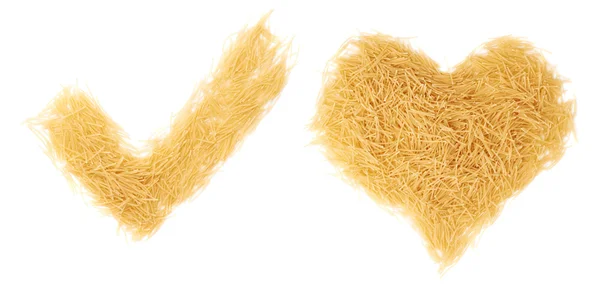 Sí signo de garrapata marca y forma de corazón hecha de pasta de fideos secos sobre fondo blanco aislado — Foto de Stock