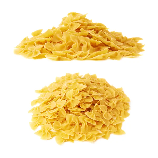 Pile of dry farfalle pasta over isolated white background — Stock Photo, Image