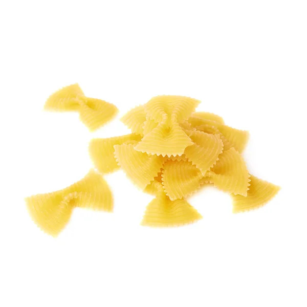 Pile of dry farfalle pasta over isolated white background — Stock Photo, Image