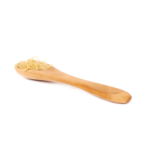 Wooden spoon filled with dry noodles pasta over isolated white background — Stock Photo, Image