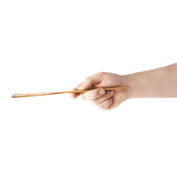 Hand holding a wooden spatula, composition isolated over the white background — Stock Photo, Image