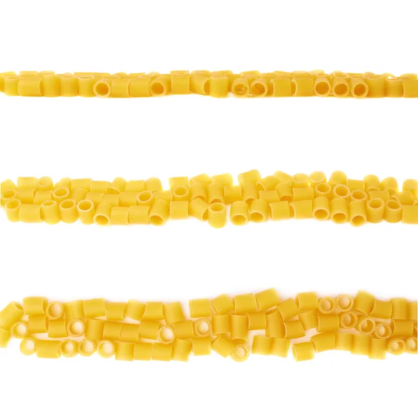 Line made of dry ditalini pasta over isolated white background — Stock Photo, Image