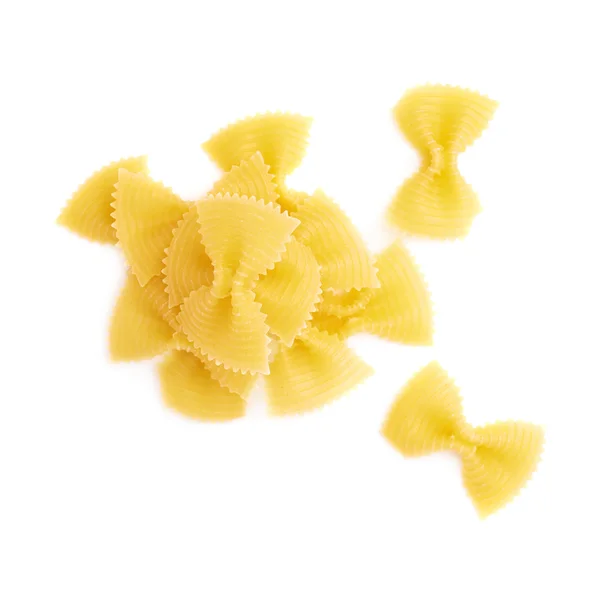 Pile of dry farfalle pasta over isolated white background — Stock Photo, Image