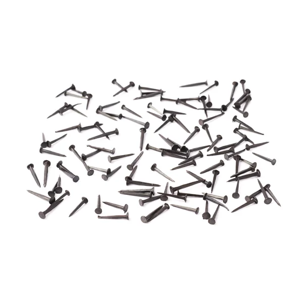 Scattered nails over surface isolated over white background — Stock Photo, Image