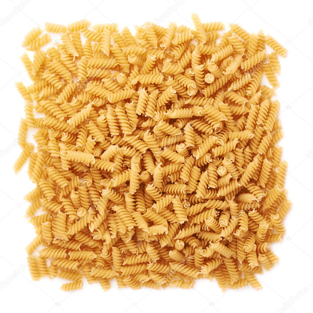 Pile of dry rotini pasta over isolated white background Stock Photo by