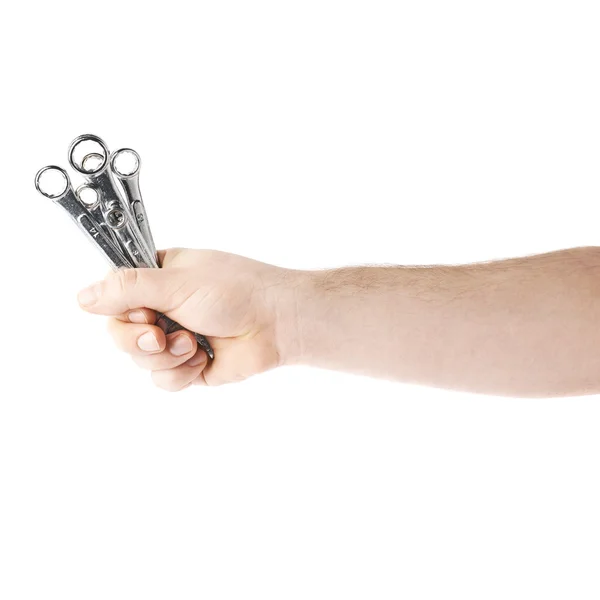 Χέρι κρατώντας ένα κλειδί εργαλεία, σύνθεση απομονώνεται πάνω από το λευκό φόντο — Φωτογραφία Αρχείου