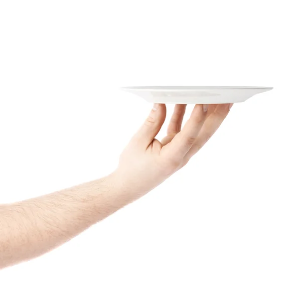 Hand holding a plate, composition isolated over the white background — Stock Photo, Image