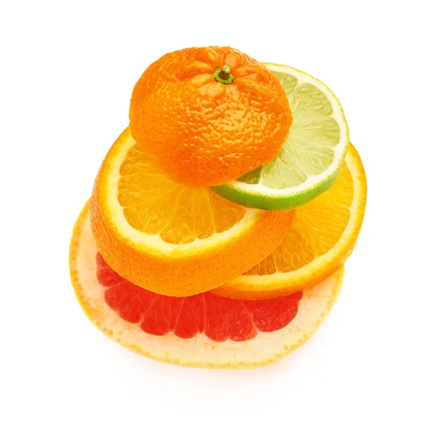 Stack of citrus sliced fruits over white isolated background — Stock Photo, Image