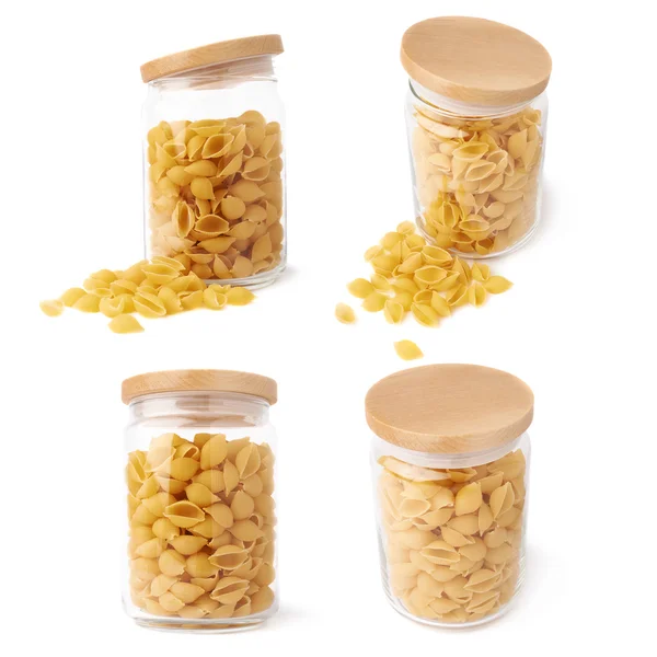 Set of glass jar filled with dry conchiglie pasta over isolated white background — Stock Photo, Image