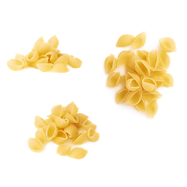 Pile of dry conchiglie pasta over isolated white background — Stock Photo, Image