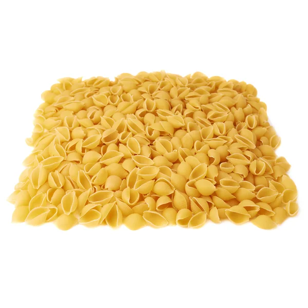 Pile of dry conchiglie pasta over isolated white background — Stock Photo, Image