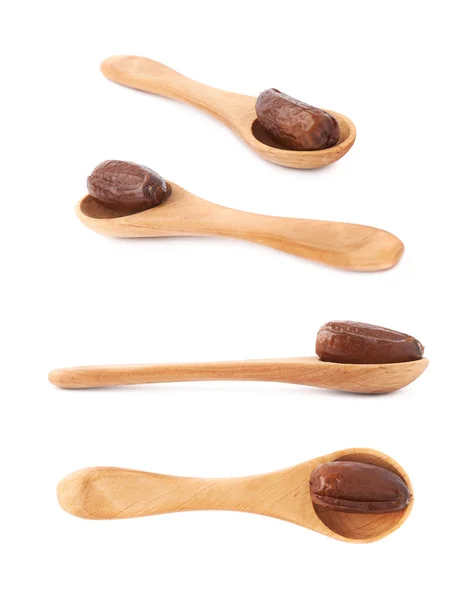 Date fruit in wooden spoon over white isolated background surface — Stock Photo, Image