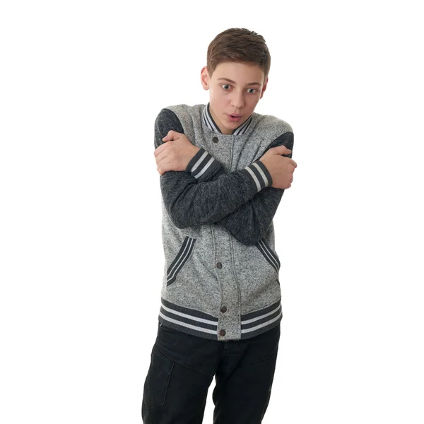 Niedlicher Teenager Junge in grauem Pullover über weißem isoliertem Hintergrund — Stockfoto