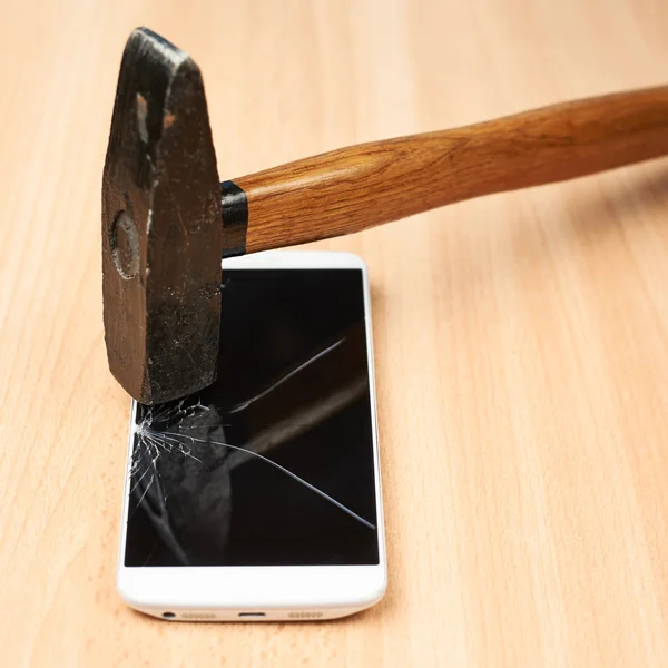 Hammer and broken phone — Stock Photo, Image