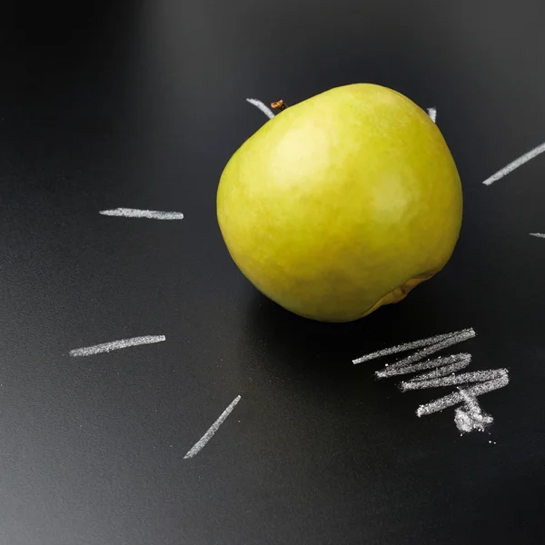 Apple over the blackboard — Stock Photo, Image