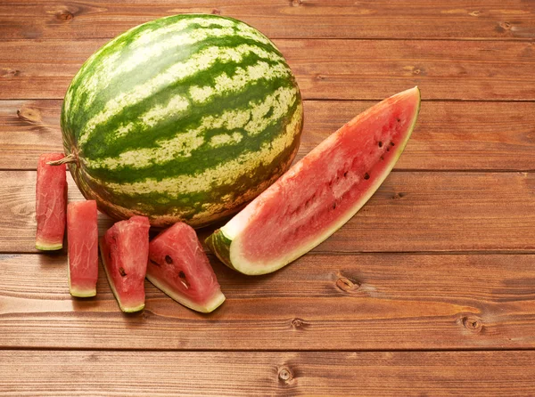 Watermelon on wooden table — Stock Photo, Image