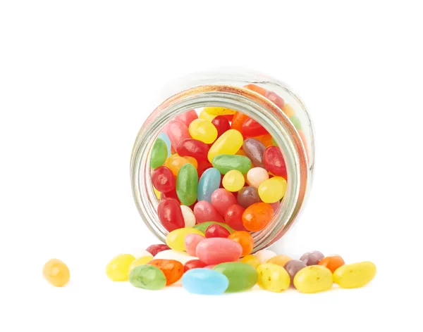 Jelly bean candies spilled out of jar — Stock Photo, Image