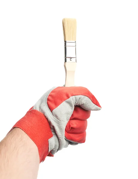 Hand in a working glove holding brush — Stock Photo, Image