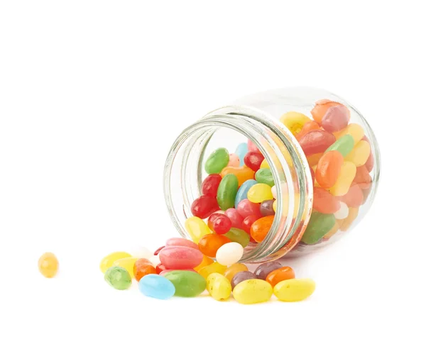 Jelly bean candies spilled out of jar — Stock Photo, Image