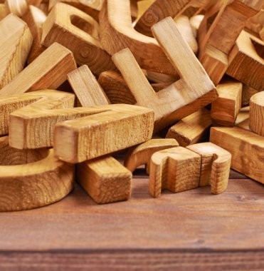 Pile of wooden letters over the wooden surface