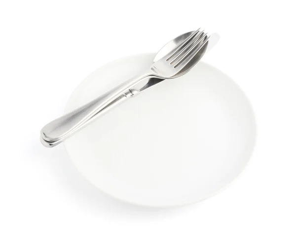 Colher, garfo e faca sobre a placa branca — Fotografia de Stock