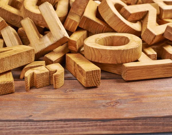 Montón de letras de madera sobre la superficie de madera — Foto de Stock