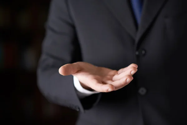 Businessman holding a open palm — Stock Photo, Image