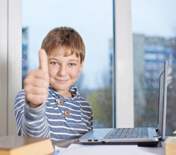 Boy  against the notebook showing  thumbs up — Stock Photo, Image