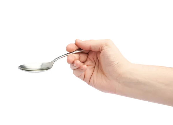 Male hand holding a spoon with oil — Stock Photo, Image