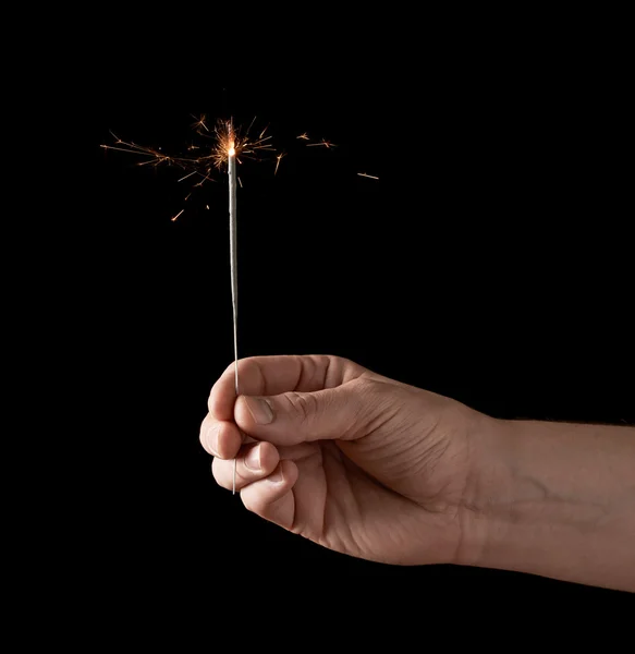 Holding a burning sparkler — Stock Photo, Image