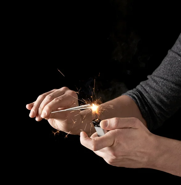 Lighting up a sparkler with lighter — Stock Photo, Image