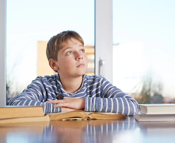 Boy sitting  over the books — Stock Photo, Image