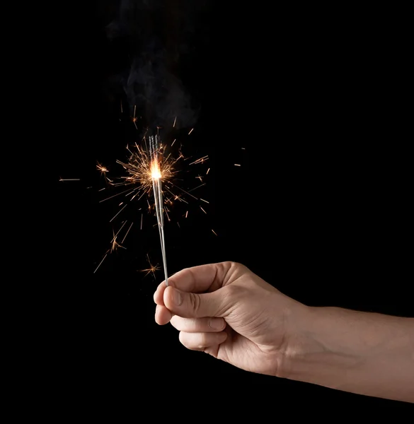 Holding a burning sparkler — Stock Photo, Image