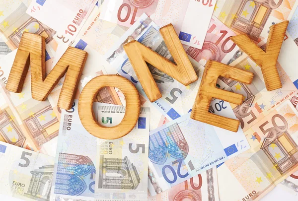 Word Money over the pile of money — Stock Photo, Image