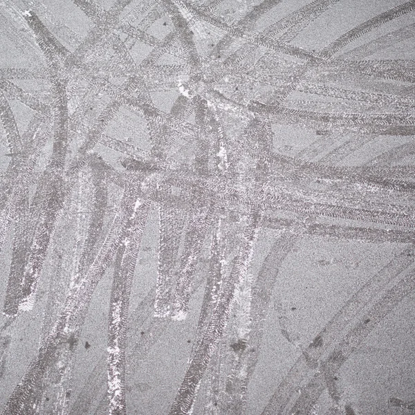 Frosted asphalt covered with the tire tracks — Stock Photo, Image