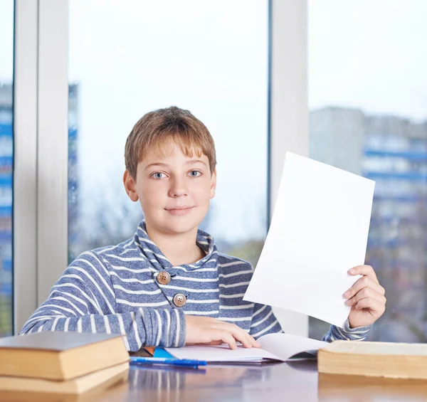 Boy  showing A4 sheet of paper — Stock Photo, Image