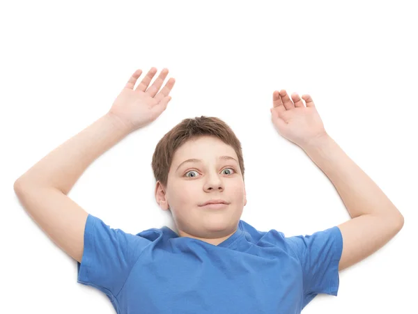 Lying on the white surface young boy — Stock Photo, Image