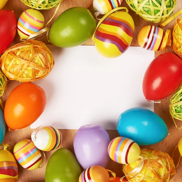 Easter eggs around white card — Stock Photo, Image