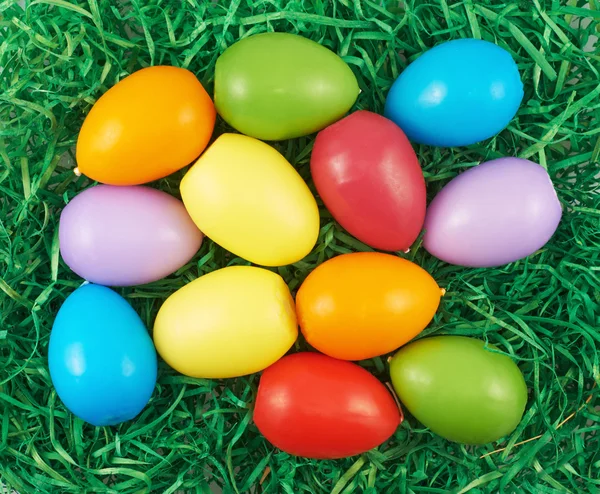 Colorful Easter eggs over green ribbons — Stock Photo, Image