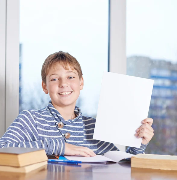 Boy  showing A4 sheet of paper — Stock Photo, Image