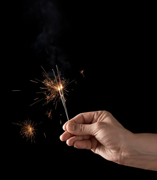 Holding a burning sparkler — Stock Photo, Image