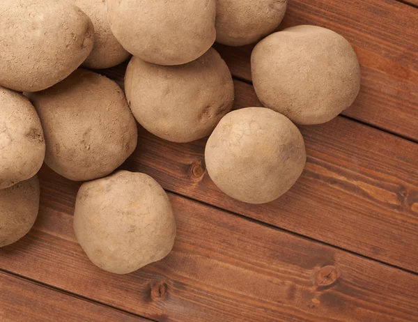 Pile of potatoes over the wooden surface — Stock Photo, Image