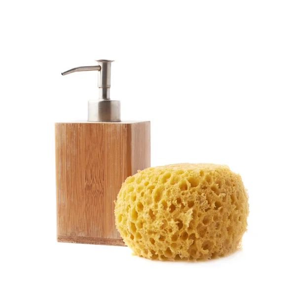 Soap dispenser and yellow sponge — Stock Photo, Image