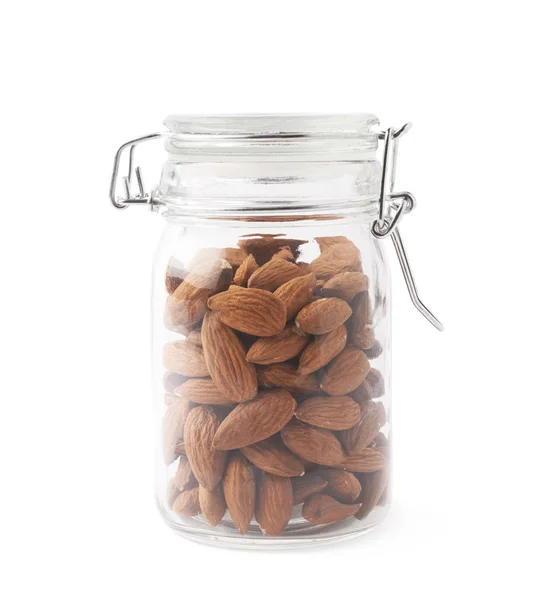 Glass jar filled with almonds — Stock Photo, Image