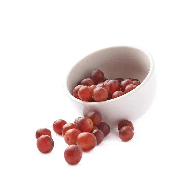 Dark red grapes spilled out of bowl — Stock Photo, Image