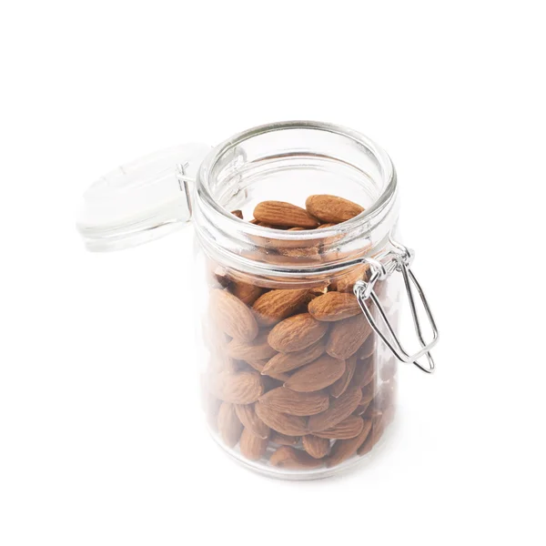 Glass jar filled with almonds — Stock Photo, Image