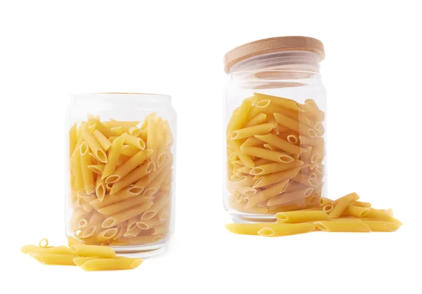 Glass jars filled with penne pasta — Stockfoto