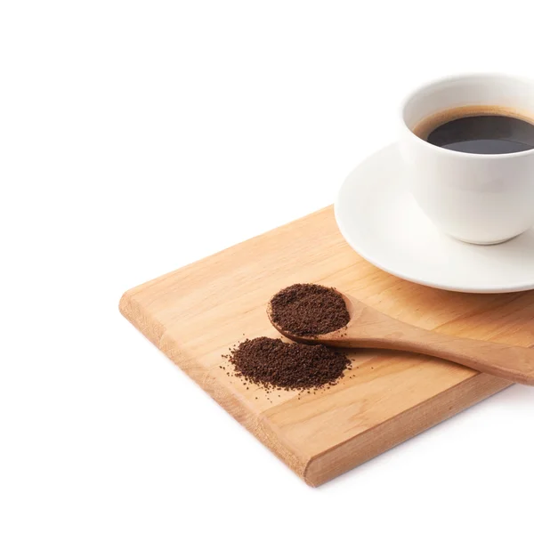 Löffel gemahlener Kaffee und Tasse auf einem Teller — Stockfoto