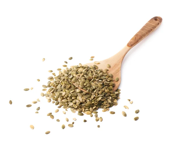 Spoon covered with pumpkin seeds — Stock Photo, Image