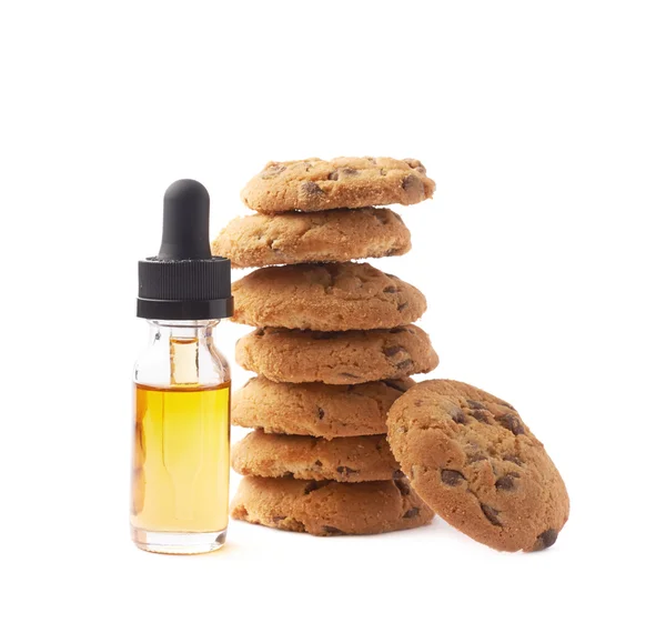 Oil essence next to cookies — Stock Photo, Image